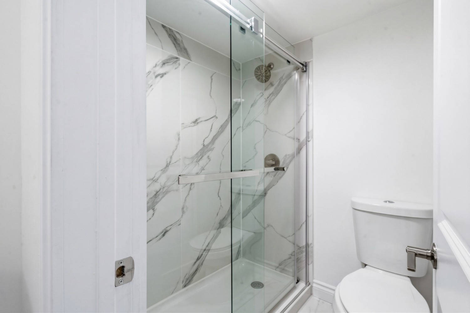 a bathroom with a shower and toilet
