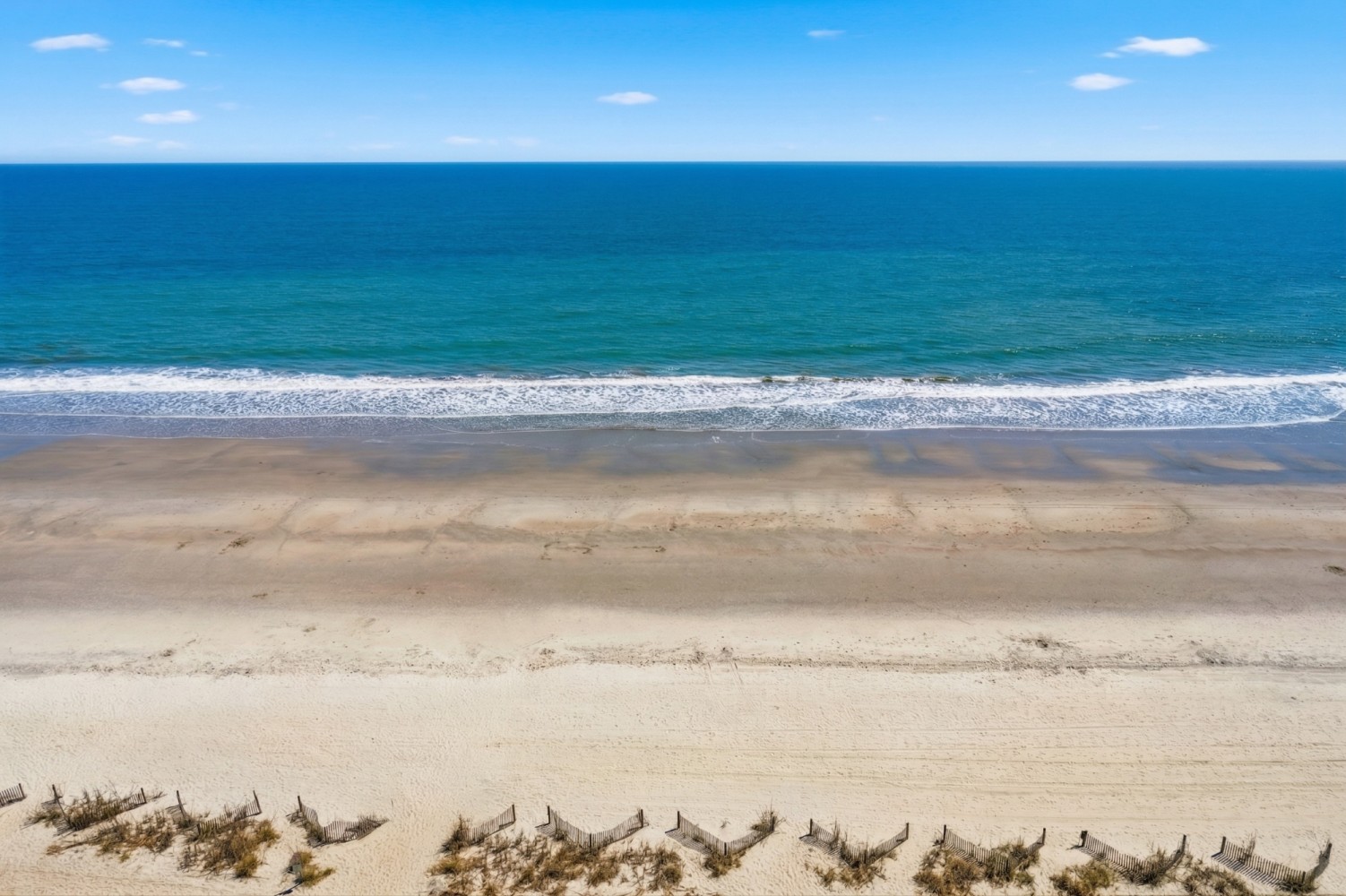 A serene beach scene with waves gently lapping at the shore.